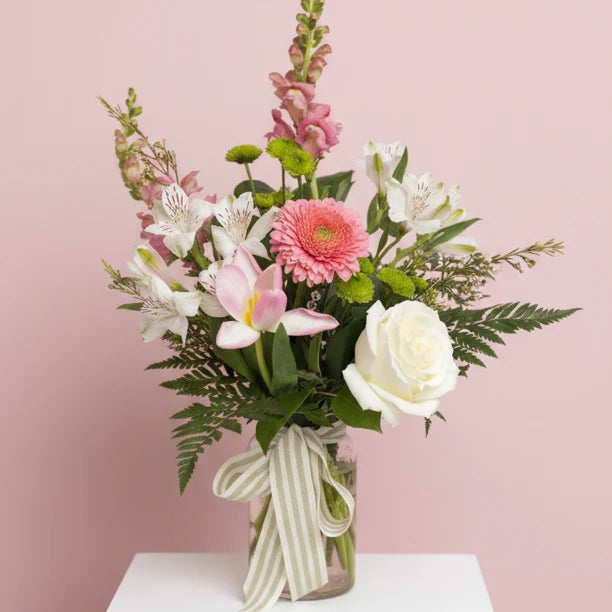 Colorful flower arrangement in hammered glass vase